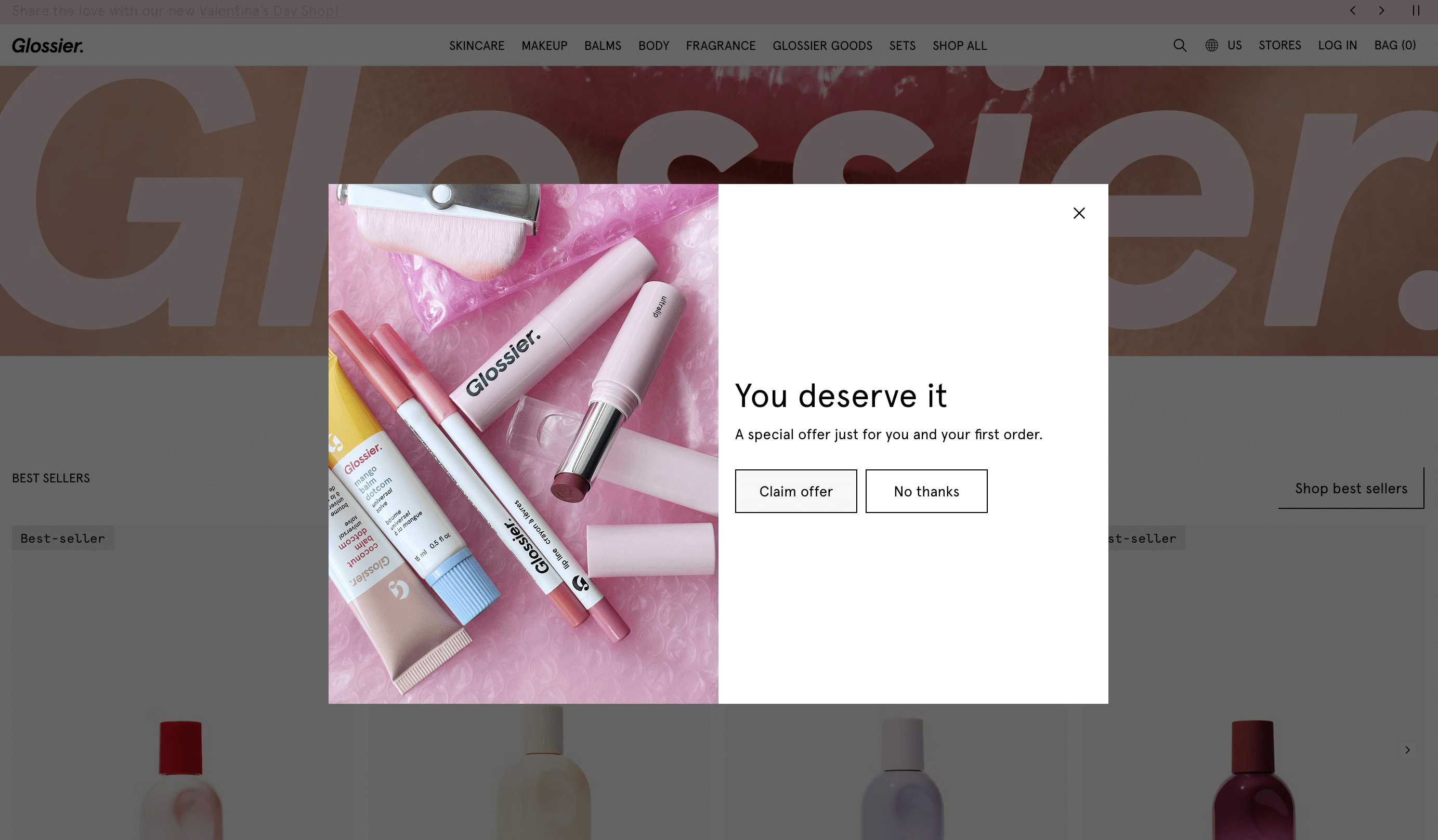 Shopify customer segmentation: A pop-up on the Glossier website features pink and white makeup products on a pink surface, with the text: You deserve it. A special offer just for you and your first order. Two buttons read Claim offer and No thanks.